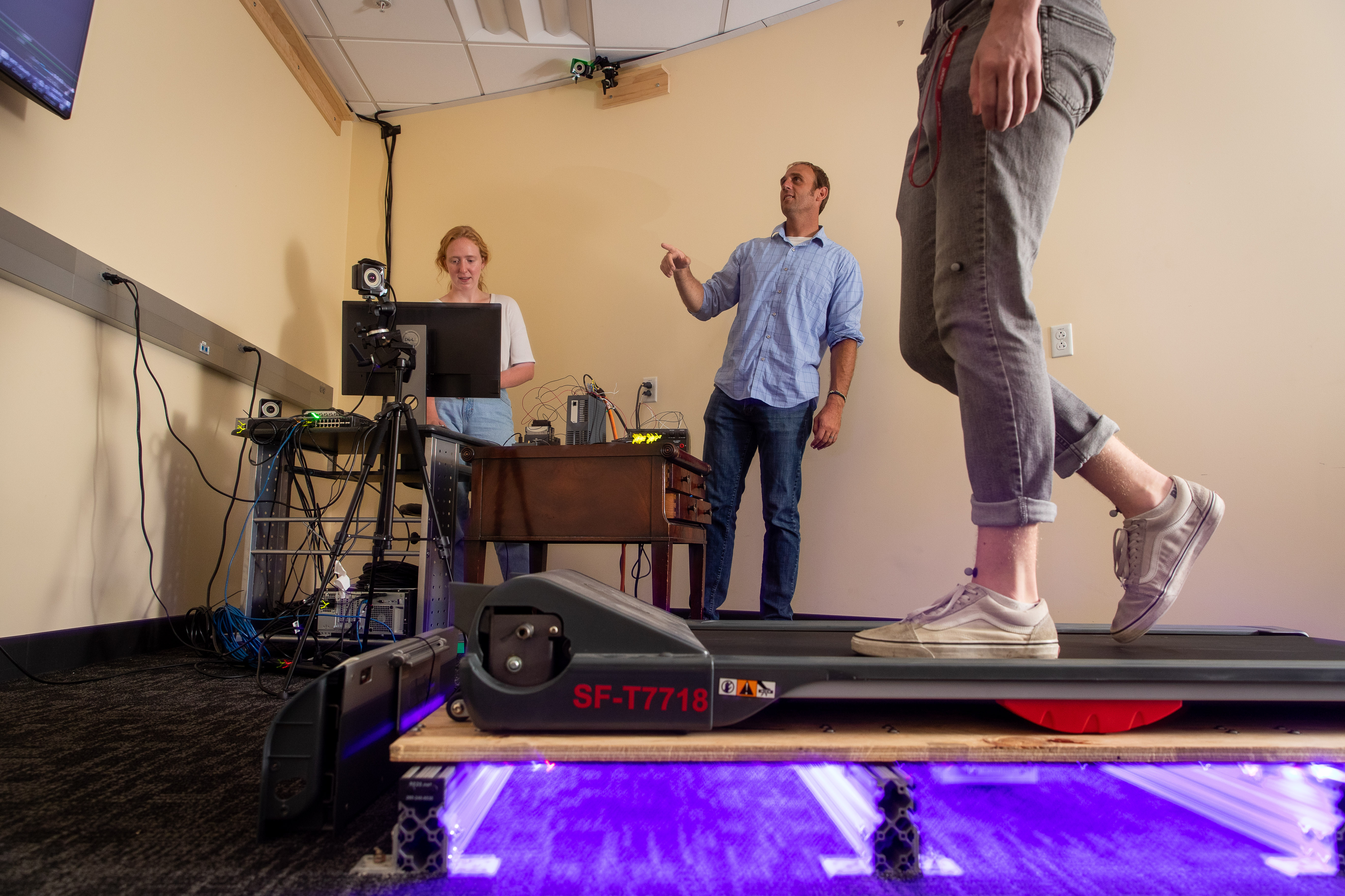 Adam Goodworth and student researchers on a treadmill